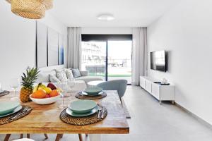 a living room with a table with fruit on it at Playa Carabassi Sea View Apartment in Gran Alacant, Large Terrace in Gran Alacant