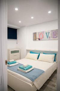 a bedroom with a large bed with towels on it at DANICO PLAYA HONDA 218 in Playa de las Americas +36 photos
