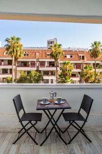 a table and chairs with a view of a building at DANICO PLAYA HONDA 218 in Playa de las Americas