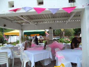 un grupo de personas sentadas en mesas con sábanas rosas en Heatherdale Guesthouse & Shuttle Services, en Pretoria