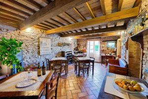 a dining room with wooden tables and chairs and a room with tables and chairsktop at B&B Il Soccorso in Mercatello sul Metauro