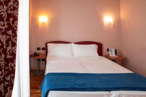 Postel nebo postele na pokoji v ubytování SIRIOHotel