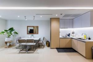 a kitchen and dining room with a table and chairs at Iconic skyline, Big apartment, Great location in Bangkok