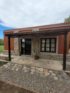 a small house with a stone exterior at Casa de Campo Don Valentin in Tunuyán