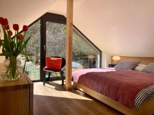 a bedroom with a bed and a vase of flowers at Iris Apartments in Obertraun
