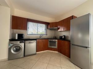 a kitchen with a refrigerator and a dishwasher at Villa Demetra, Coral Bay in Coral Bay