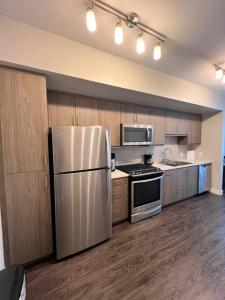a kitchen with a stainless steel refrigerator and appliances at 1 Bdr Apt in Irvine - Near John Wayne in Irvine