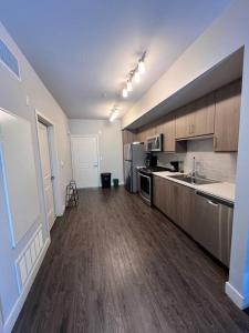 a large kitchen with wooden floors and appliances in a building at 1 Bdr Apt in Irvine - Near John Wayne in Irvine
