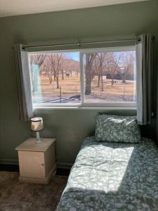 a bedroom with a bed and a large window at Helper Sunrise Peak in Helper +25 photos