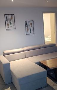 a living room with a couch and a table at IFESTIA HOUSE in Agia Paraskevi