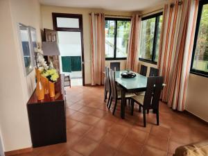 a dining room with a table and chairs at Hikers Haven in Faial