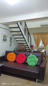 a couch with colorful pillows on it in a living room at Mactan Oasis Garden 401 in Mactan