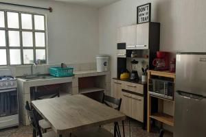 a kitchen with a table and a wooden table in it at Apartment in Colonia Molina in Quetzaltenango