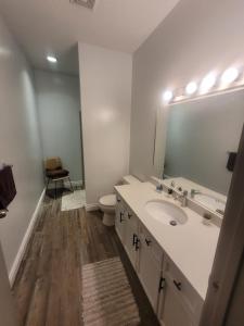 a bathroom with a sink and a toilet and a mirror at Wissem in Edmonton