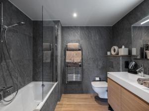 a bathroom with a shower and a toilet and a sink at Résidence Goyard - Chalets pour 12 Personnes 184 in Courchevel