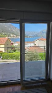 an open window with a view of a body of water at 2BR sea view apartment in Kotor! in Kotor