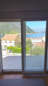 an open window with a view of a balcony at 2BR sea view apartment in Kotor! in Kotor