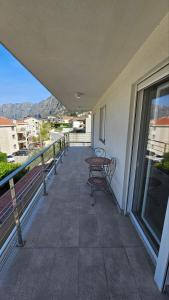a balcony with a table and chairs on a building at 2BR sea view apartment in Kotor! in Kotor