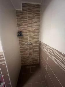 a shower with a glass door in a bathroom at Una-No1 in Bihać