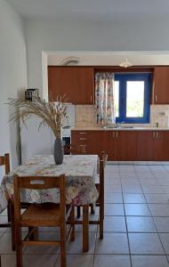 a kitchen with a table with a vase on it at Melissa Apartments in Frangokastello