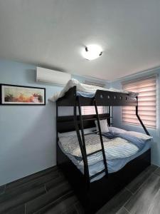 a bedroom with two bunk beds in a room at American Standard/2Bedroom House in Cagayan de Oro