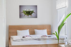 a bedroom with a bed with a wooden headboard at Apartmány Rozárka Turnov in Turnov