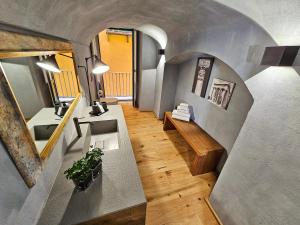 a room with a sink and a table in a house at Porta Antica - OldTown Salerno in Salerno