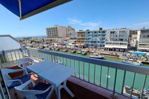 a balcony with a table and chairs and a harbor at Palavas in Palavas-les-Flots