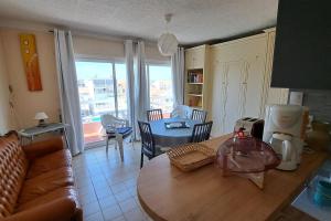 a living room with a couch and a table at Palavas in Palavas-les-Flots