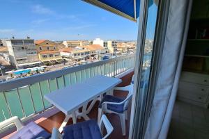 a table on a balcony with a view of a city at Palavas in Palavas-les-Flots +1 photo