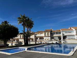 a large swimming pool in front of some buildings at Casa Del Sol in Gran Alacant
