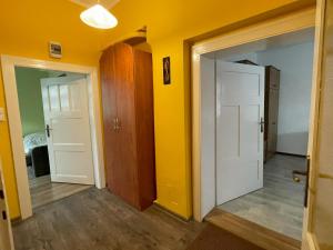 an empty room with yellow walls and two doors at Apartament 2-pokojowy 55 m2, koło ZOO, Hali Stulecia in Wrocław