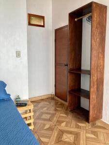 Schlafzimmer mit einem Bett und einem Holzschrank in der Unterkunft Suite frente al mar - CIELO in Montañita