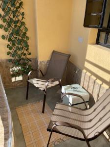 a couple of chairs sitting on a porch at Executive Cozy Furnished Apartment-In Utawala, NBO, Near JKIA in Nairobi