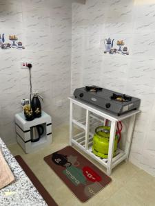 a pretend kitchen with a stove and a microwave at Executive Cozy Furnished Apartment-In Utawala, NBO, Near JKIA in Nairobi