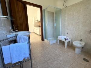 a bathroom with a sink and a toilet at Il Poggio del Cilento Country House in Agropoli