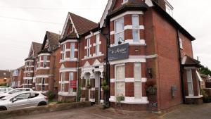a red brick building with a sign on it at The Mayfair guest house self catering in Southampton