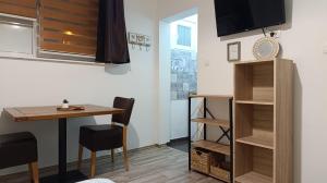 a small kitchen with a table and a dining room at Apartment Mana in Mostar