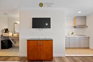 a kitchen with a flat screen tv on a wall at Gateway Lodge in Seaside