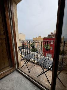 uma vista para uma varanda com um banco a partir de uma janela em La Casita Hermosa em Alicante