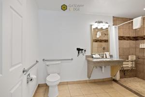 a bathroom with a toilet and a sink at Gateway Lodge in Seaside