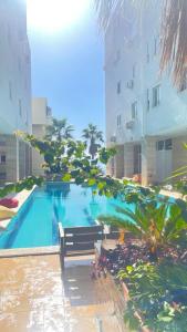 a swimming pool with a bench next to a building at Sea Scape Apartment 3 in Vlorë