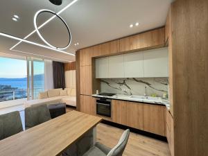 a kitchen and dining room with a dining table at Sea Scape Apartment 3 in Vlorë