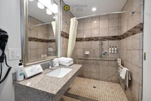 a bathroom with a sink and a shower at Gateway Lodge in Seaside