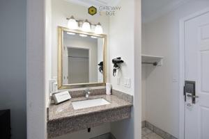 a bathroom with a sink and a mirror at Gateway Lodge in Seaside