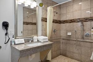 a bathroom with a sink and a shower at Gateway Lodge in Seaside