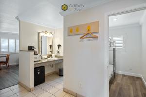 a bathroom with a sink and a mirror at Gateway Lodge in Seaside