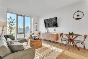 a living room with a couch and a table at Prime NYC Waterfront Gem in Mott Haven