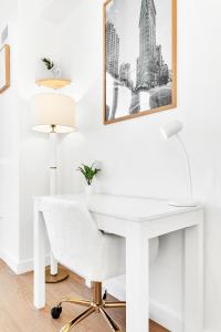 białe biurko z krzesłem i zdjęciem na ścianie w obiekcie Prime NYC Waterfront Gem w mieście Mott Haven