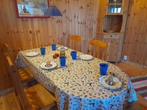 a table with blue cups and plates of food on it at Letten in Brograngen